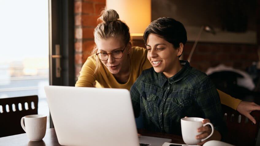 Cropped shot of a young couple using wireless technology at home.