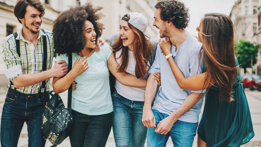 Group of mixed race people outdoors in the city, having a great time.