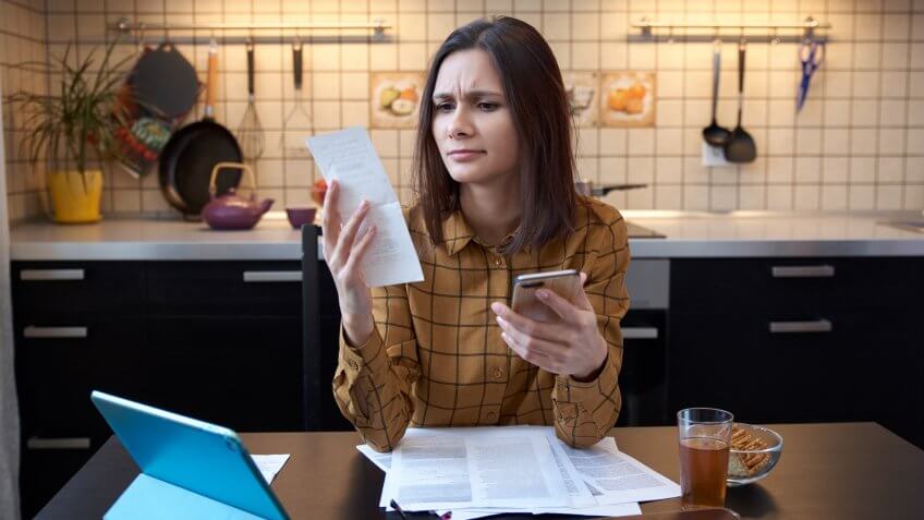 young woman looking at her bills and finances