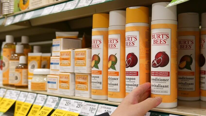Coquitlam, BC, Canada - October 08, 2015 : Woman selecting nature's burt's bees shampoo in grocery store.