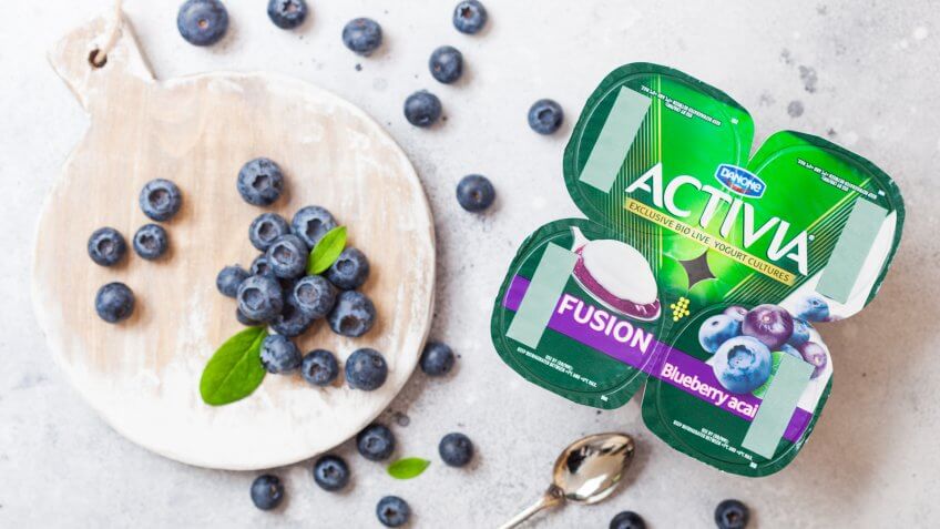 LONDON, UK - SEPTEMBER 26, 2018: Activia yogurt with blueberries by Danone with berries.