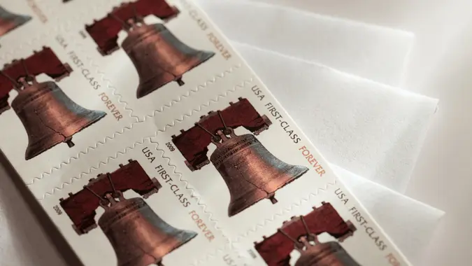 Booklet of USA Forever Stamps on envelopes.