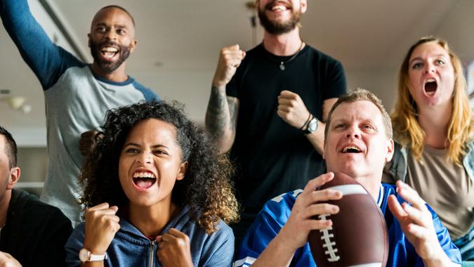Friends cheering American football together