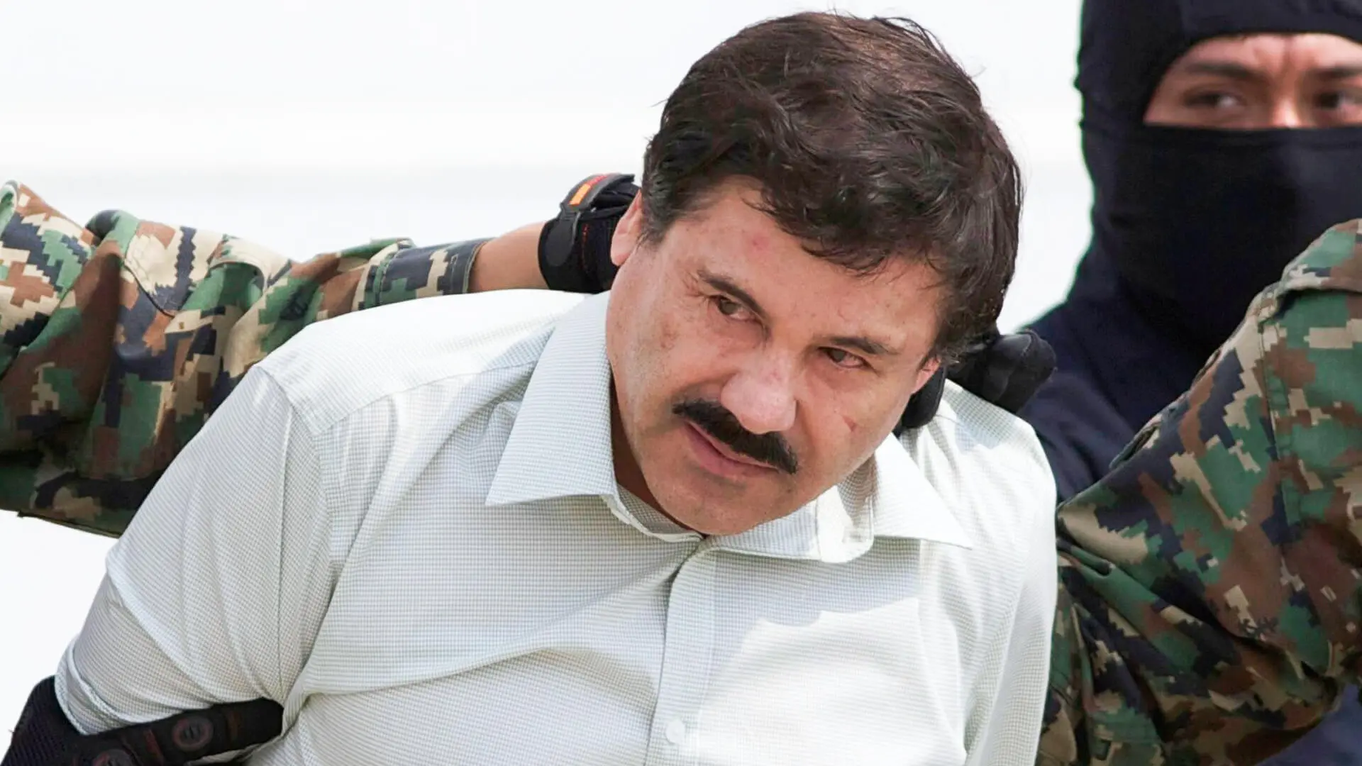 Mandatory Credit: Photo by Eduardo Verdugo/AP/REX/Shutterstock (6753558a) Joaquin "El Chapo" Guzman Joaquin "El Chapo" Guzman, head of Mexico's Sinaloa Cartel, is escorted to a helicopter in Mexico City, following his capture overnight in the beach resort town of Mazatlan.