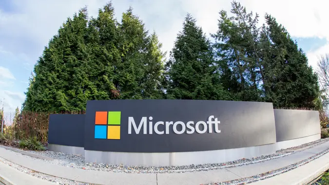 Redmond, WA, USA - January 30, 2018: One of the biggest Microsoft signs is placed next to green trees at a public intersection near Microsoft's Redmond campus.