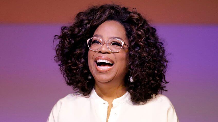 Oprah Winfrey laughing during a tribute to Nelson Mandela and promoting gender equality event at University of Johannesburg in Soweto, South Africa.