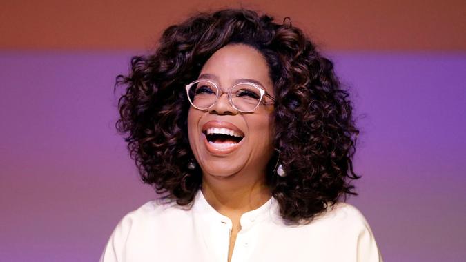 Oprah Winfrey laughing during a tribute to Nelson Mandela and promoting gender equality event at University of Johannesburg in Soweto, South Africa.
