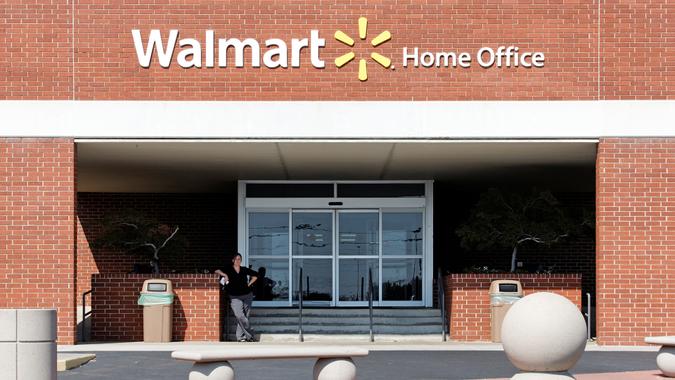 Walmart Home Office Bentonville, Arkansas, USA – October 4, 2012: An employee stands near the entrance to the Walmart Home Office in Bentonville.