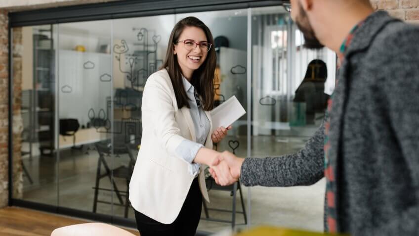 female recruiter shaking hands with interviewee