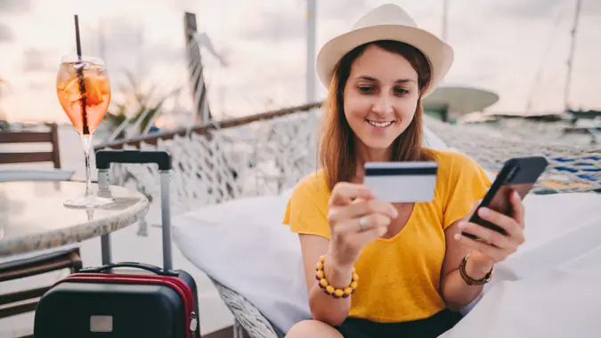 Young woman making credit card payments from smartphone.