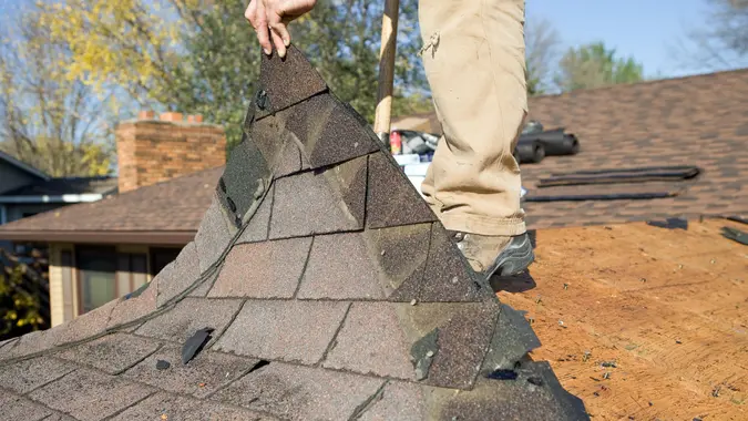 "Building Exterior, Asphalt Shingle", Building Activity, Built Structure, Chimney, Construction, Construction Site, Damaged, Demolishing, Holding, Home Improvement, Horizontal, House, Human Hand, Industry, Manual Worker, New, Old, Removing, Roof, Weathered, Wood Shingle, repairing, roofer