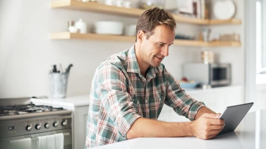 Shot of a mature man using a digital tablet at home.
