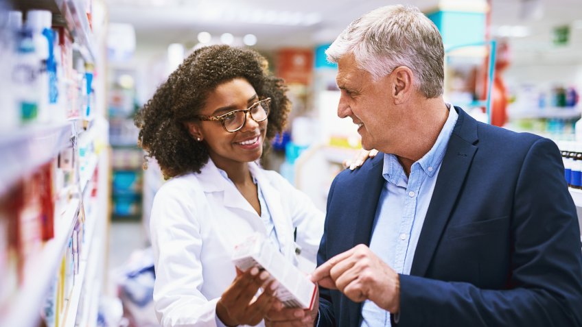 Shot of a helpful young female pharmacist helping a customer with choosing the right medication in the pharmacy.
