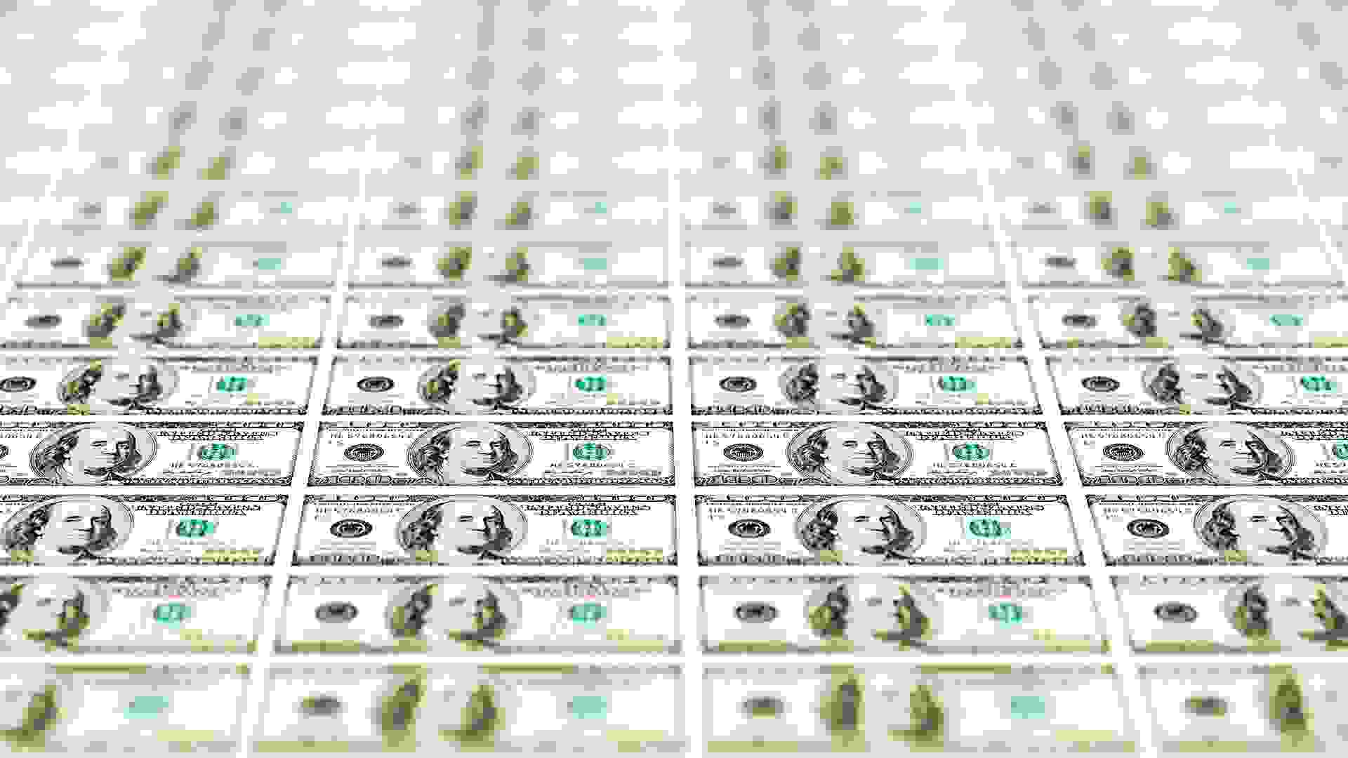 Perspective shot of hundreds of US hundred dollar bills.