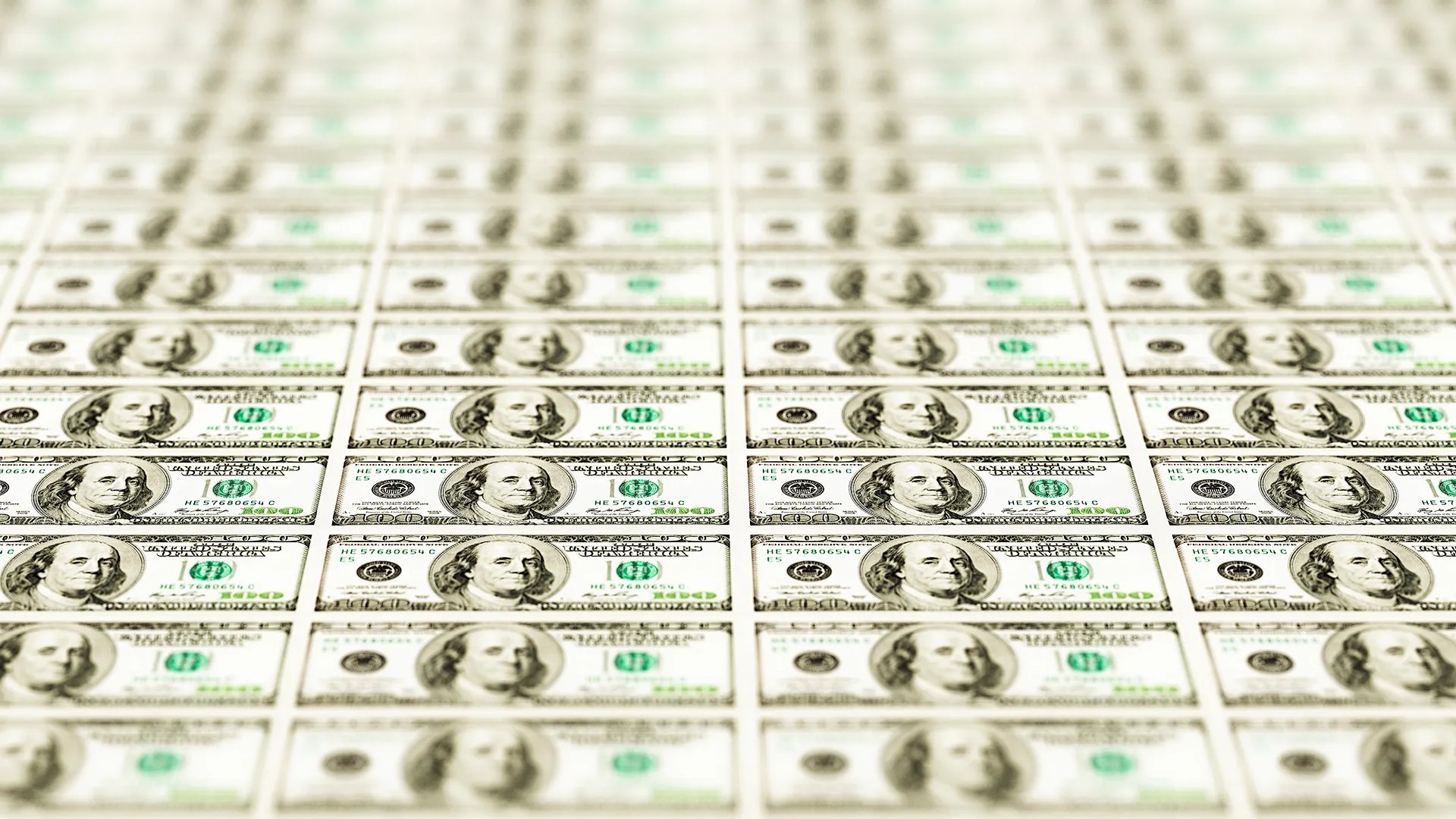 Perspective shot of hundreds of US hundred dollar bills.
