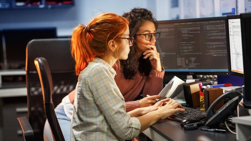 Two female programmers working on new project.