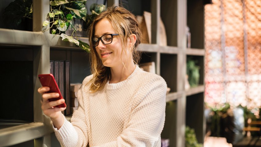 woman using her smartphone at home