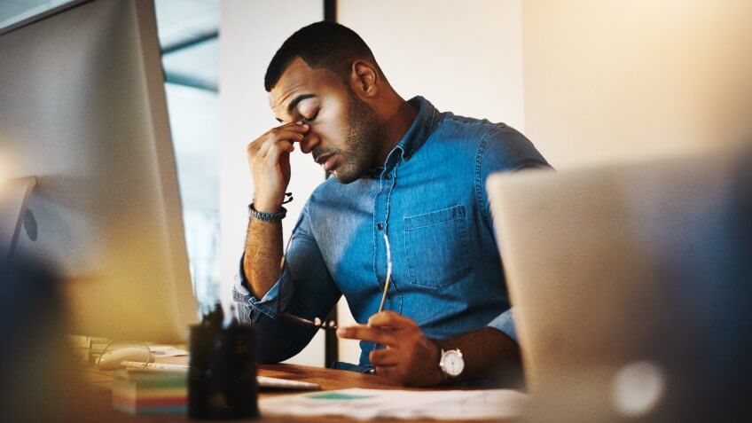 young businessman experiencing stress during a late night at work.
