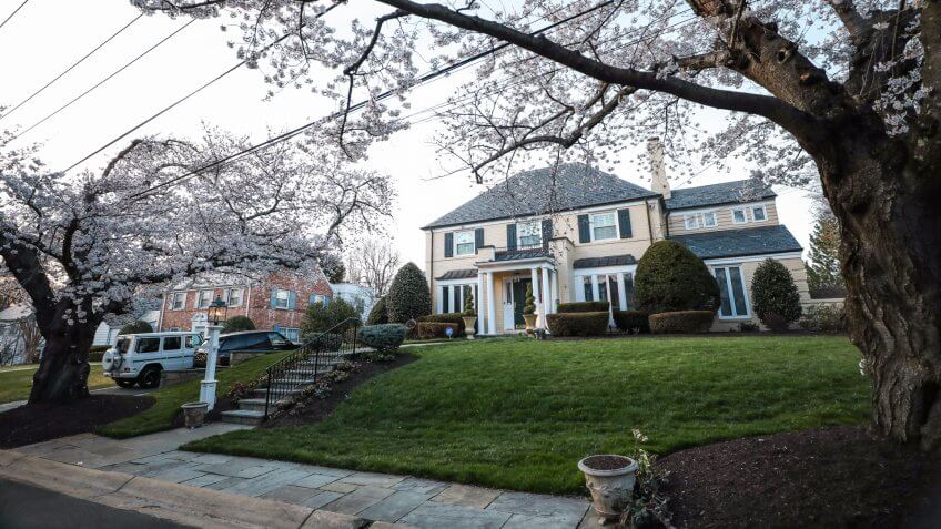 Chevy Chase, MD - April 8, 2018: A large mansion in the neighborhood of Kenwood, an area best known for its many Japanese Yoshino cherry blossom trees in the spring.