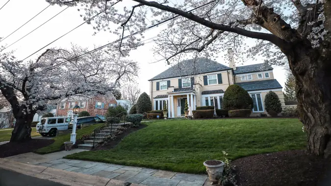 Chevy Chase, MD - April 8, 2018: A large mansion in the neighborhood of Kenwood, an area best known for its many Japanese Yoshino cherry blossom trees in the spring.