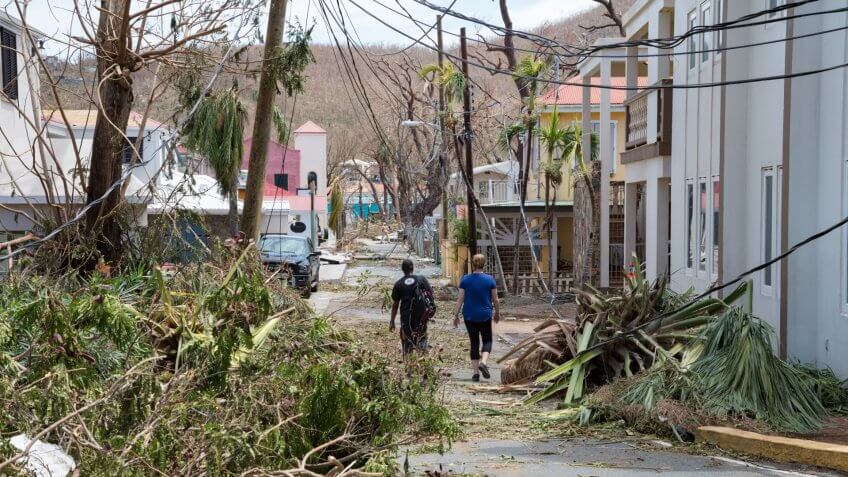 Cruz Bay, St John, US Virgin Islands - Sept 08, 2017: Aftermath of Hurricane Irma, St John, People walking past recently cleared hurricane destruction in downtown Cruz Bay, 2 days after storm.