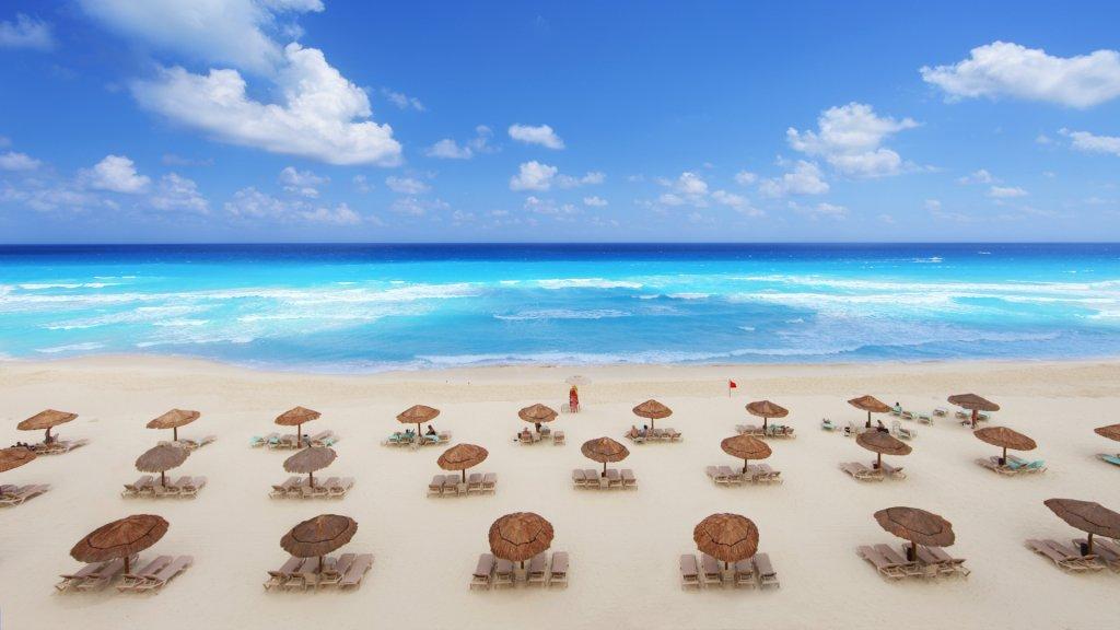 Tropical beach resort in Cancun, Mexico on a beautiful spring break day.