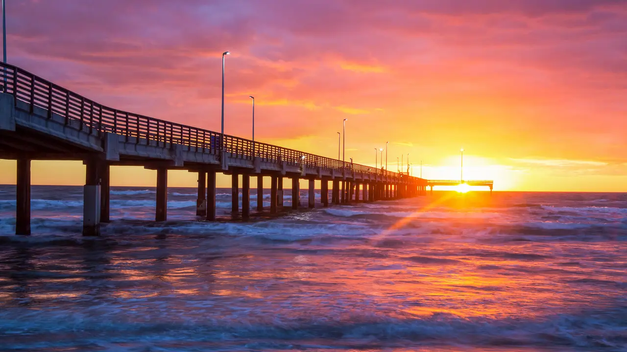 Corpus Christi Texas beach with pier at sunset