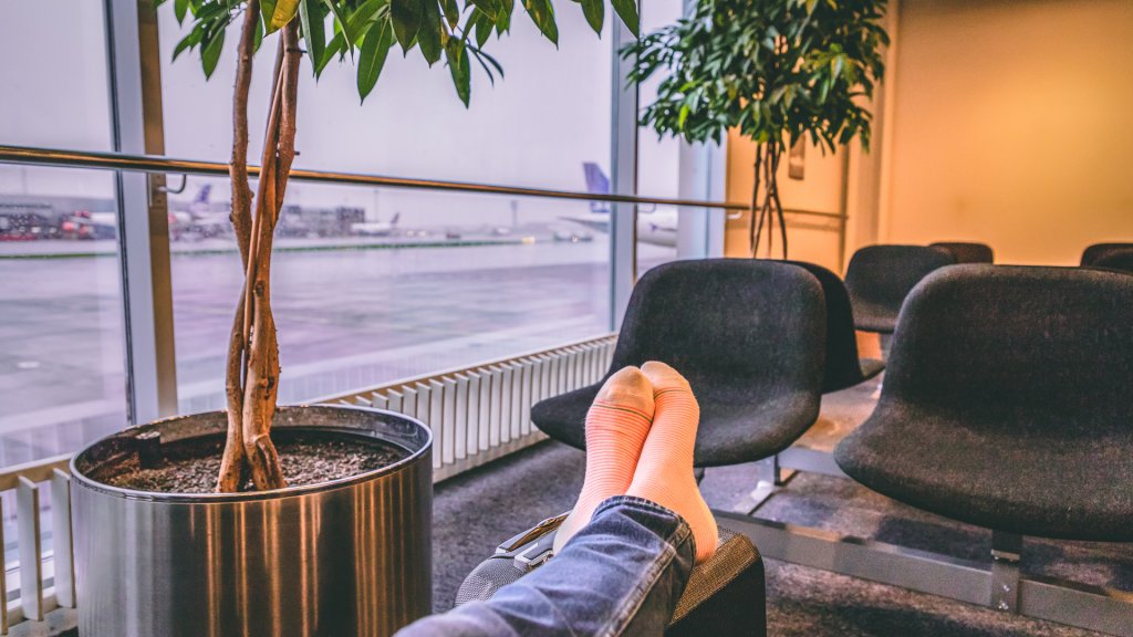 Female feet on suitcase in international airport