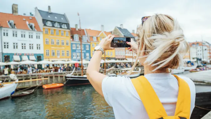 Tourists visiting famous Nyhavn, Copenhagen, Denmark.