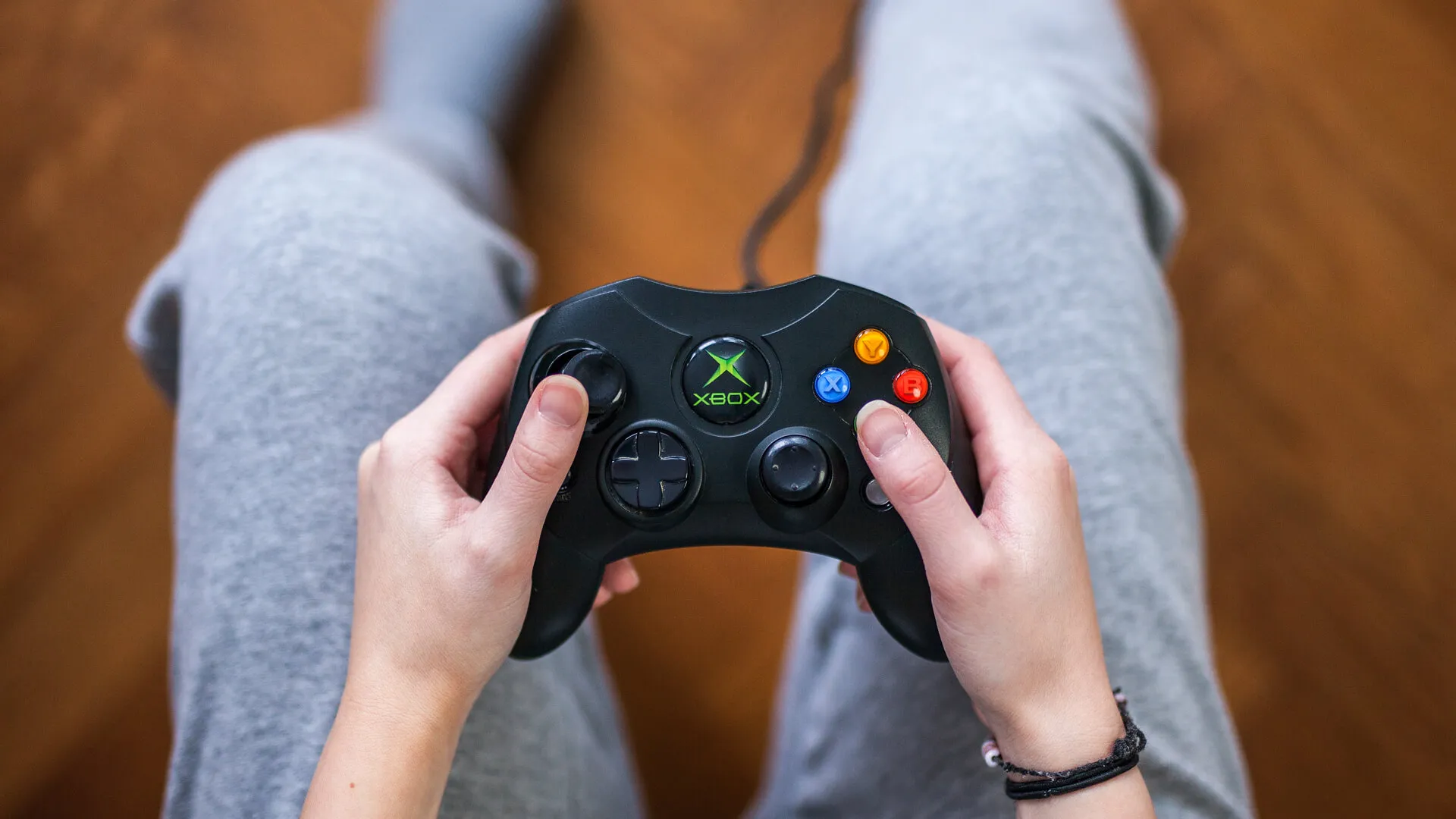 Gothenburg, Sweden - January 24, 2015: A shot from above of a young womans hands holding a game controller for the Microsoft Xbox, a video game console.