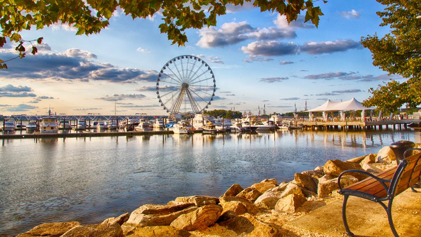 September 10, 2017, Oxen Hill, Maryland, USA: Boats dcked on the national waterfront sit in front of the pier and ferris wheeel in late summer.