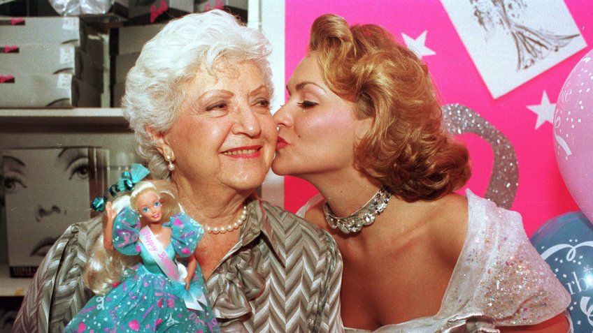 Mandatory Credit: Photo by Robert Clark/AP/REX/Shutterstock (6538610a)RUTH HANDLER Barbie doll creator Ruth Handler, left, gets a kiss from Kristi Cooke, an actress dressed as a Barbie doll, during the 35th birthday celebration for the doll at FAO Schwarz in New York City onBARBIE CREATOR RUTH HANDLER, NEW YORK, USA.