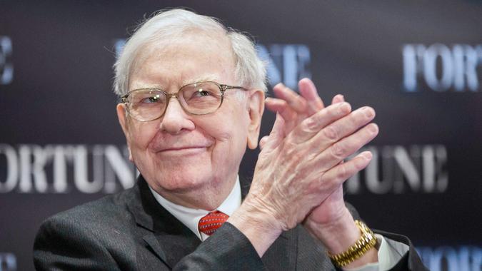 Warren Buffett claps his hands during interview