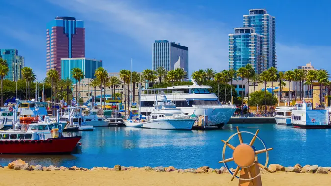 Long Beach marina with recreational boats and city skyline at Long Beach, CA.