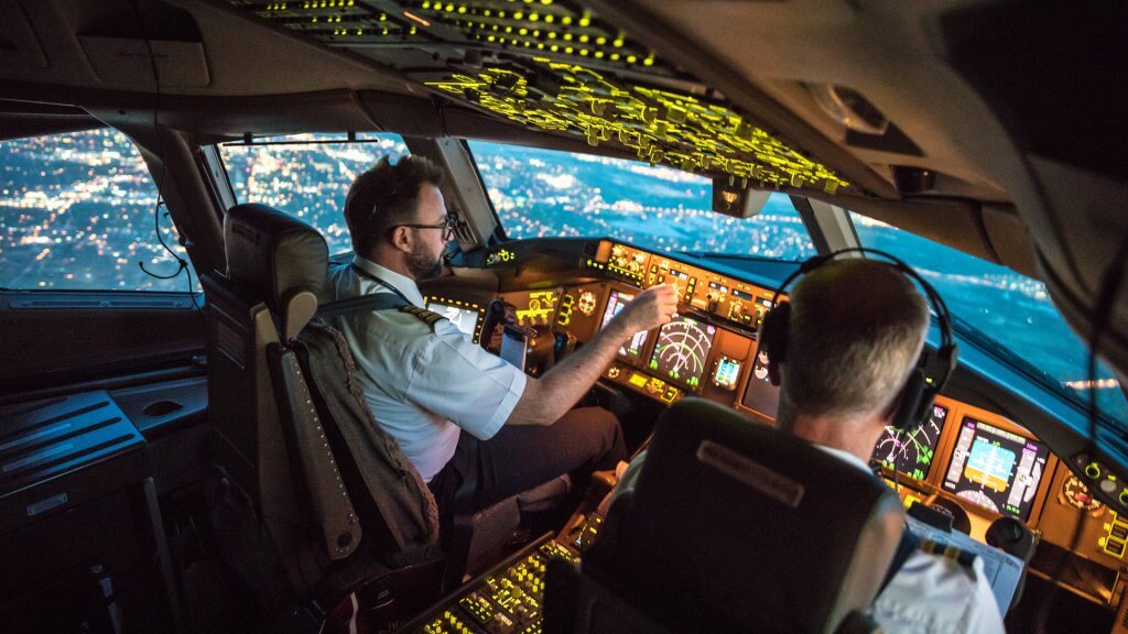 Two pilots at work during departure of Dallas Fort Worth Airport in United States of America.