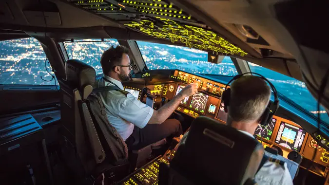 Two pilots at work during departure of Dallas Fort Worth Airport in United States of America.