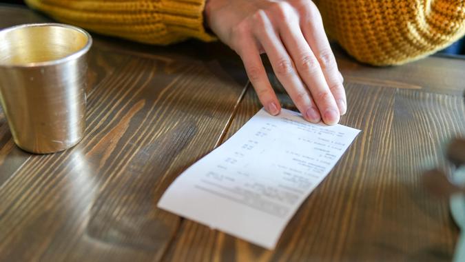 checking receipt at restaurant after meal