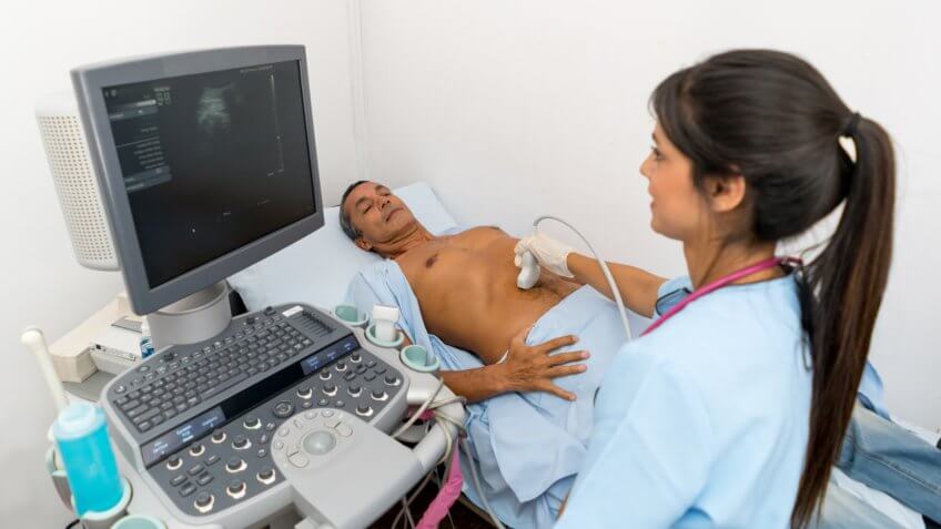 sonographer checking the organs of a patient