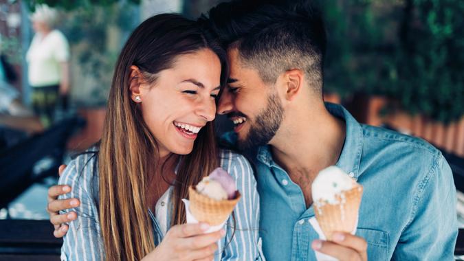 Happy young couple having date and eating ice cream.