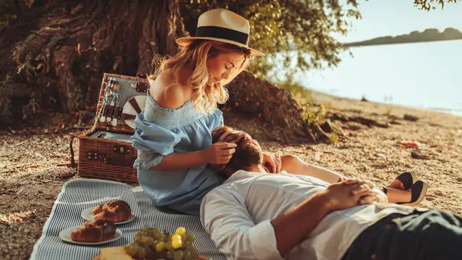 couple having afternoon picnic on beach