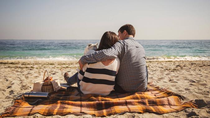 couple having afternoon picnic on the beach