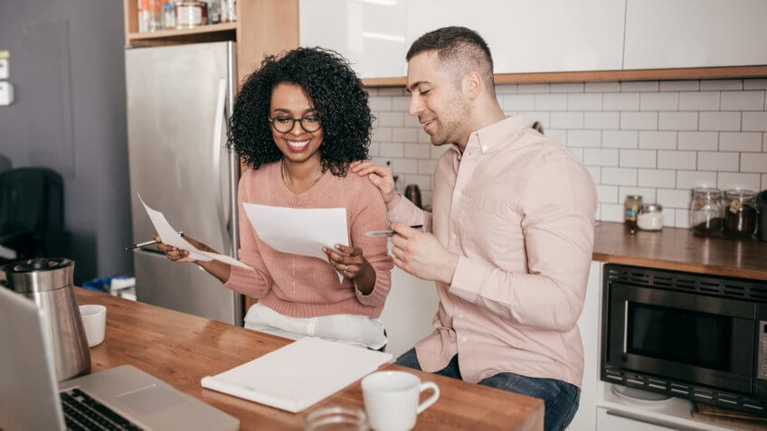 Couple planning their finances on the kitchen.