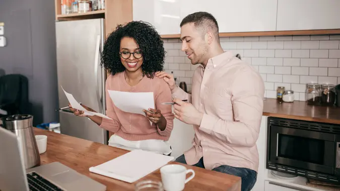 Couple planning their finances on the kitchen.