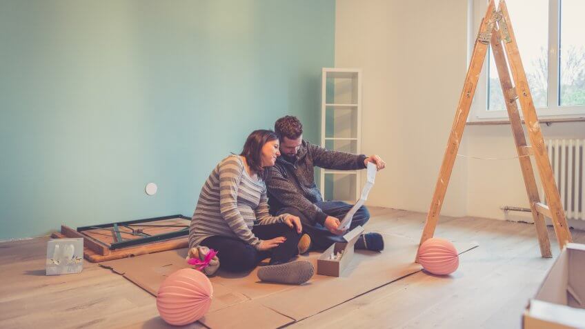 Pregnant couple in a new apartment going through their normal daily life.