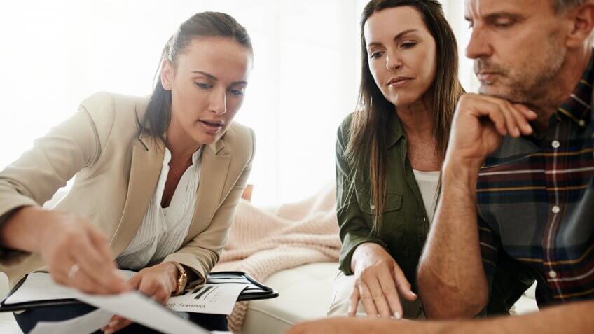 Shot of a mature couple getting advice from their financial consultant at home.