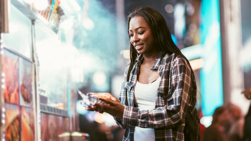 Africa American Woman at a Hot Dog Stand in Times Square, New York City.