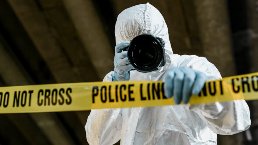 forensic science technician photographing the scene of a crime