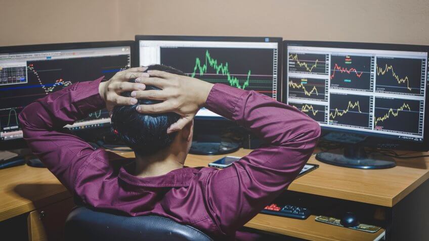 frustrated stock analyst looking at stock charts