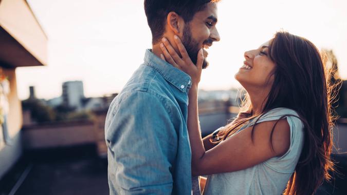 Beautiful young couple in love dating outdoors and smiling.