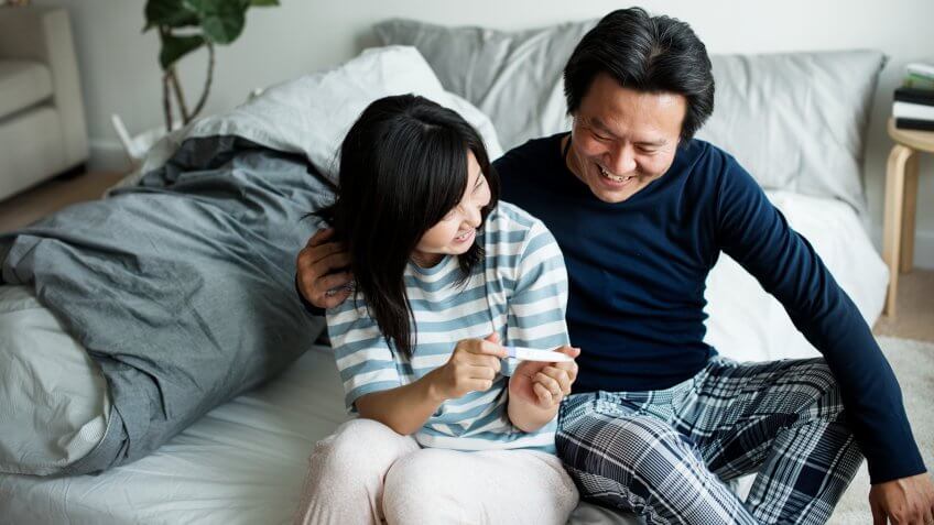 Asian couple with pregnant test.